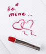 Sign on heart in a notebook and red lipstick in Valentine's Day