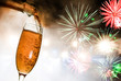 Photo: Glass with champagne against fireworks Glass with champagne against fireworks