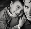 Cheerful boy hugging his proud mom