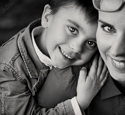 Photo: Cheerful boy hugging his proud mom Cheerful boy hugging his proud mom