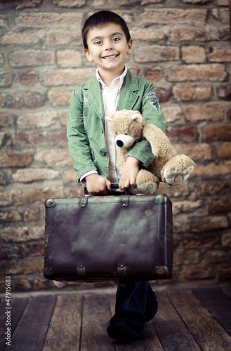 Photo: Stylish boy with suitcase Stylish boy with suitcase