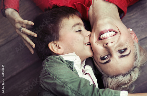 Photo: Young boy kissing his mom Young boy kissing his mom