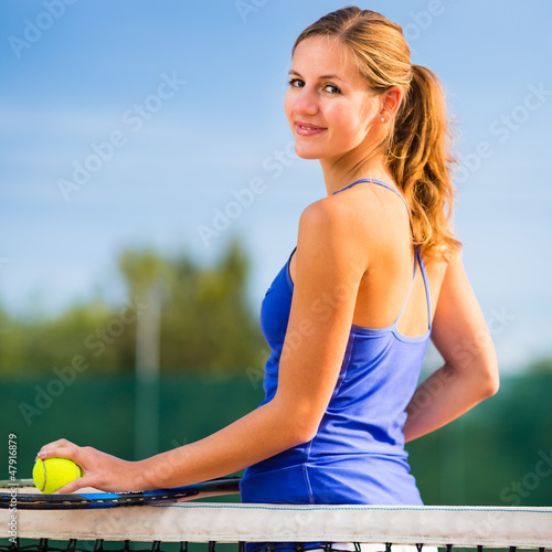 Photo: Portrait of a pretty young tennis player with copyspace Portrait of a pretty young tennis player with copyspace