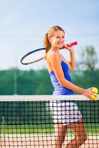 Photo: Portrait of a pretty young tennis player with copyspace Portrait of a pretty young tennis player with copyspace
