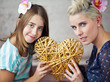 Mother and daughter keeping toy heart