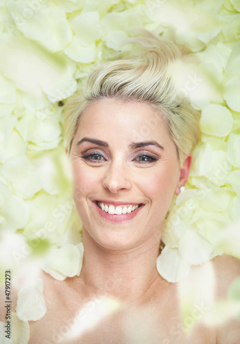 Photo: Attractive short-hair woman among white petals Attractive short-hair woman among white petals