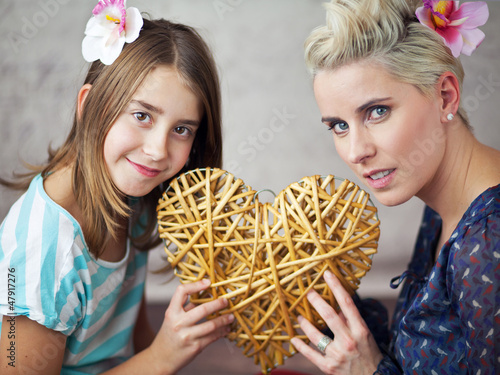 Photo: Mother and daughter keeping toy heart Mother and daughter keeping toy heart