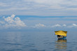 A yellow fisherman boat in the Turquoise Tropical Water