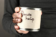 homeless man asks for help, on black background close-up
