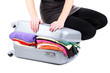 Girl tries to close the suitcase isolated on white