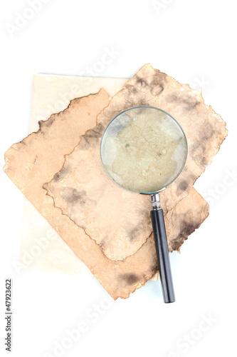 Photo: Old paper with magnifying glass isolated on white Old paper with magnifying glass isolated on white