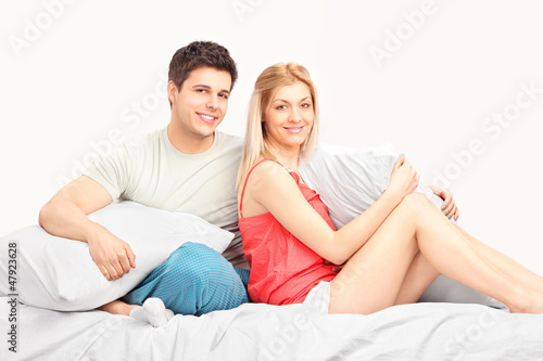Photo: Lovely heterosexual couple in pajamas in a bed Lovely heterosexual couple in pajamas in a bed
