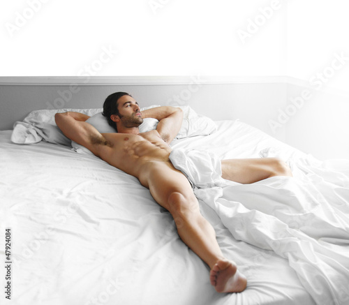 Photo: Sexy man body in bed Sexy man body in bed