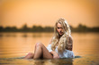 Sexy blonde woman in lingerie in a river water.Sexy on the beach