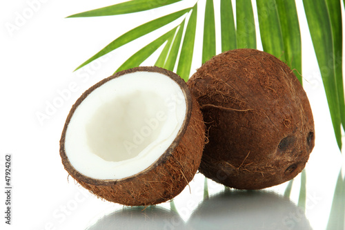 Photo: Coconuts with leaves and flower, isolated on white Coconuts with leaves and flower, isolated on white