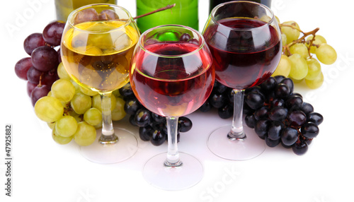 Photo: bottles and glasses of wine and assortment of grapes, isolated bottles and glasses of wine and assortment of grapes, isolated