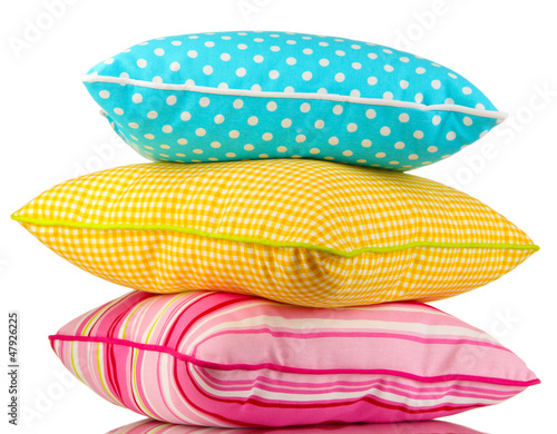 Photo: Blue, pink and yellow bright pillows isolated on white Blue, pink and yellow bright pillows isolated on white