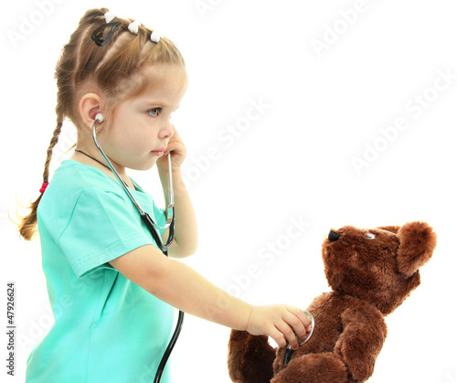 Photo: little girl doctor with toy bear, isolated on white little girl doctor with toy bear, isolated on white
