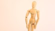 Doll-dummy move hands and incline body on white background