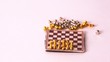 Small chessmen by turns fall from chessboard on white background