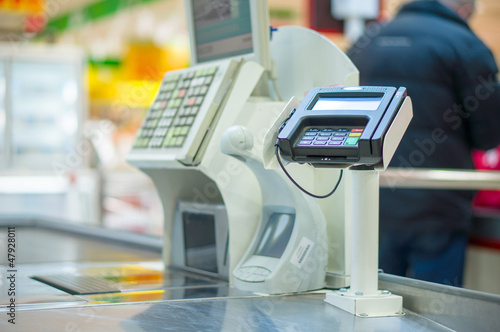 Photo: Empty cash desk with terminal in supermarket Empty cash desk with terminal in supermarket