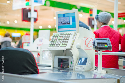 Photo: Empty cash desk with terminal in supermarket Empty cash desk with terminal in supermarket