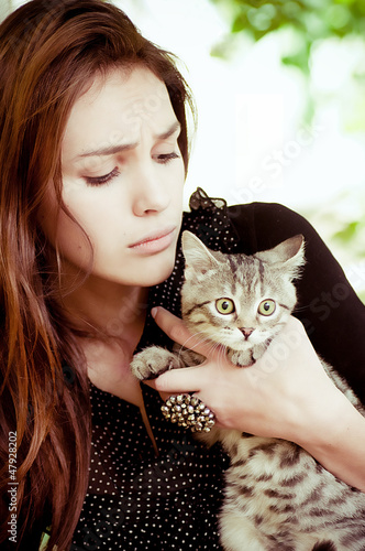 Photo: Surprised girl with a little cat Surprised girl with a little cat