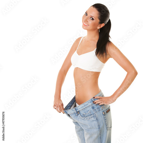 Photo: Funny woman shows her weight loss by wearing an old jeans, isola Funny woman shows her weight loss by wearing an old jeans, isola