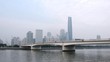 Cars go on bridge standing in front of Zhujiang New Town in