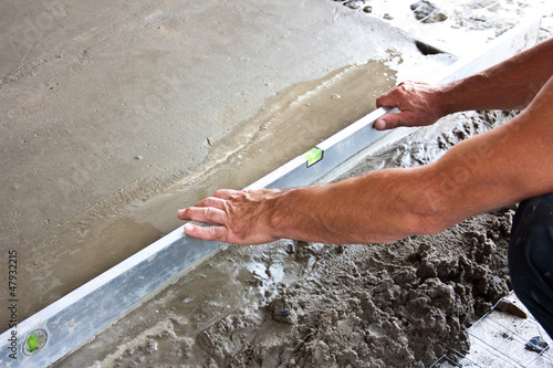 Photo: Plasterer concrete worker at floor work Plasterer concrete worker at floor work