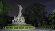 Tourists are photograph at left to Sculpture of Five Rams in
