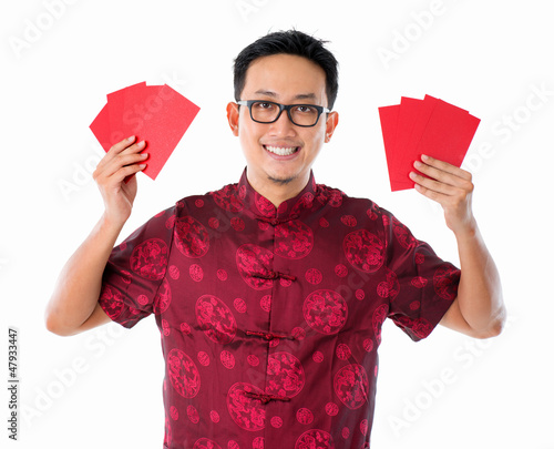 Photo: Asian Chinese man holding red packet Asian Chinese man holding red packet