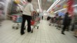 People walk and are engaged in purchases in shopping centre