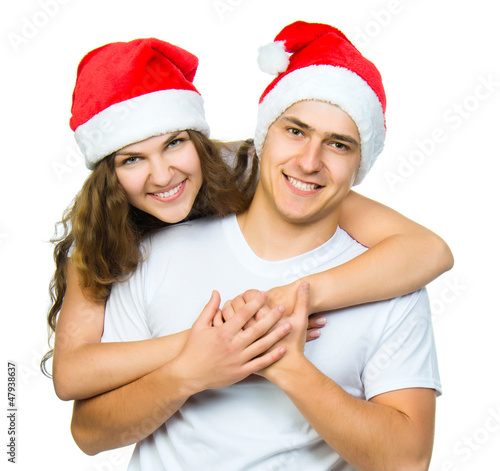 Photo: Beautiful Christmas couple in Santa hats Beautiful Christmas couple in Santa hats