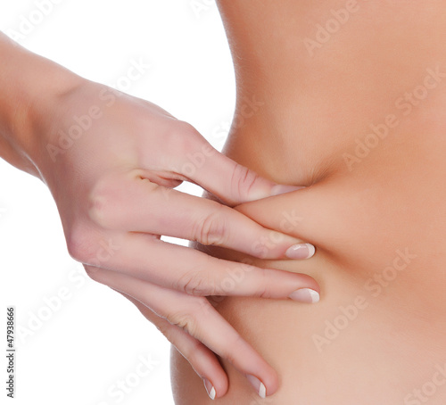 Photo: woman pinches fat on the belly, isolated on white woman pinches fat on the belly, isolated on white