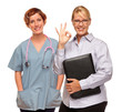 Photo: Businesswoman Making Okay Hand Sign with Doctor or Nurse Businesswoman Making Okay Hand Sign with Doctor or Nurse