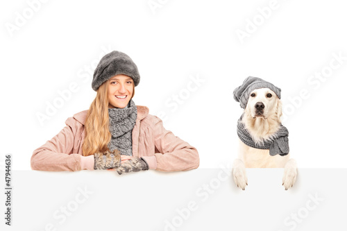 Photo: A smiling female posing with labrador retriever dog behind a pan A smiling female posing with labrador retriever dog behind a pan