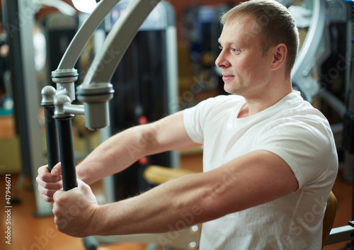 Photo: Exercising in gym Exercising in gym