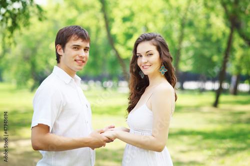 Photo: Young love Couple smiling under blue sky Young love Couple smiling under blue sky