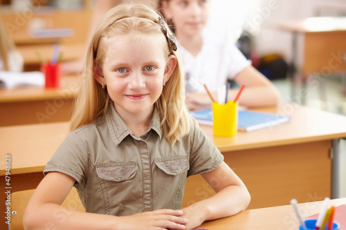 Photo: Little girl at school class Little girl at school class