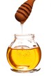 Jar of honey with wooden drizzler isolated on white background