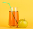 Useful apple juice with apples around on yellow background