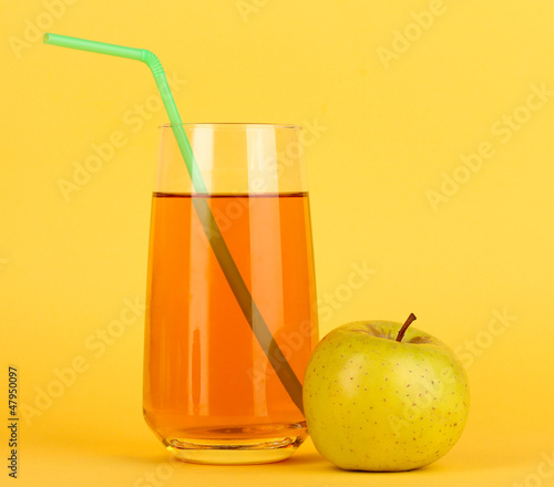Photo: Useful apple juice with apples around on yellow background Useful apple juice with apples around on yellow background