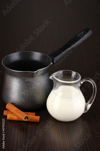 Photo: Coffee maker and milk on brown table Coffee maker and milk on brown table