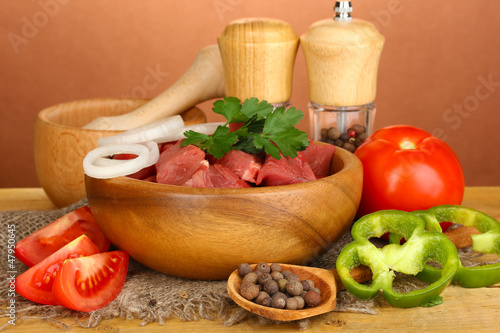Photo: Raw beef meat with herbs and spices Raw beef meat with herbs and spices