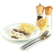 Dish of herring and lemon on plate isolated on white