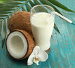 Coconuts with glass of milk,  on blue wooden background