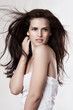 Sensual young woman with beautiful long brown flying hairs