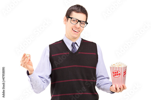 Photo: Smiling man eating popcorn Smiling man eating popcorn