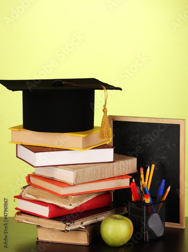 Photo: Books and magister cap against school board Books and magister cap against school board